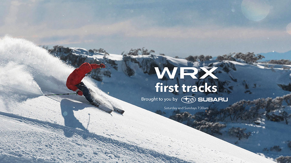 Skier skiing down mountain next to Subaru WRX Blue model  