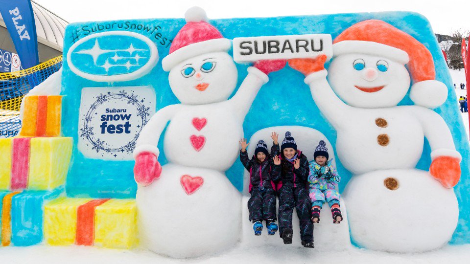 Subaru snow sculpture with two snowman and 3 kids at Perisher