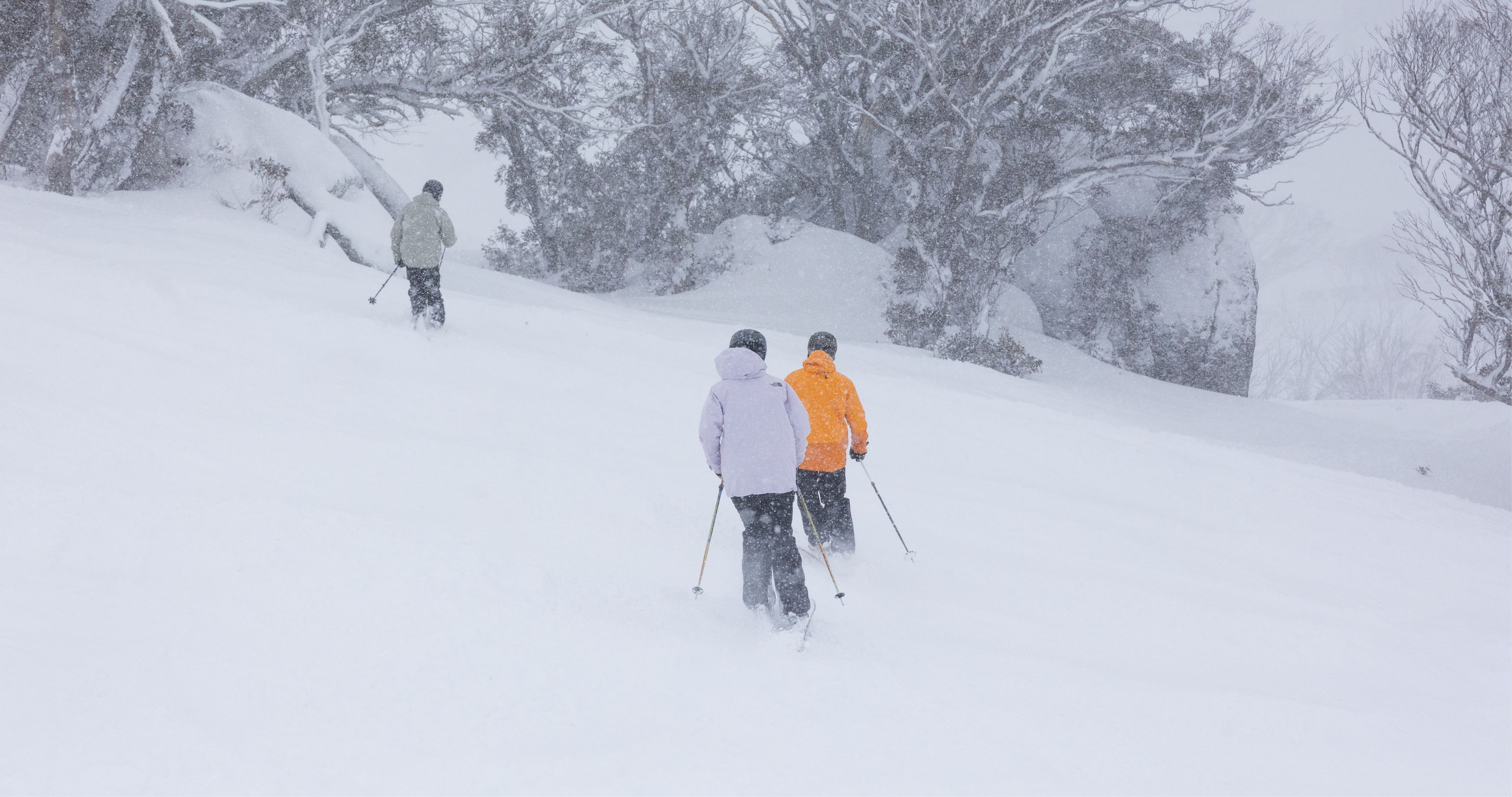 3 people skiing in snow