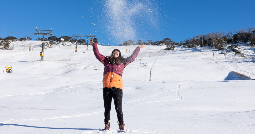 Girl throws snow in air