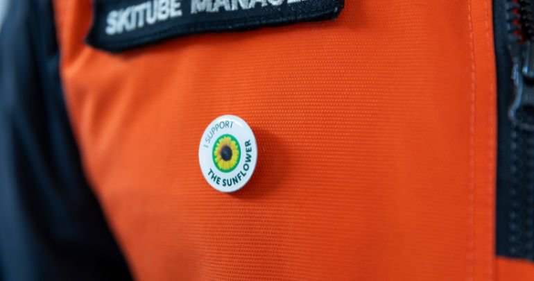 Close-up of a Hidden Disabilities Sunflower lanyard and card worn by a young guest