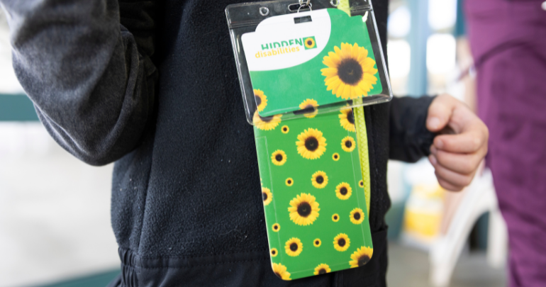 'I support the Sunflower' pin badge worn by a Skitube Manager